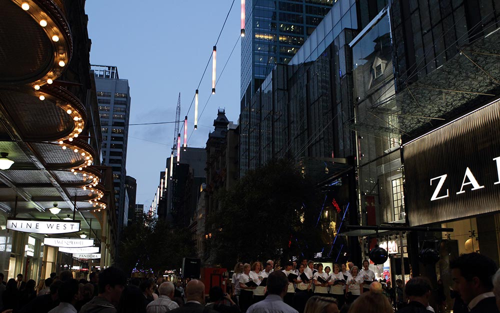 The Pitt Street Mall catenary lighting system illuminates the pedestrian areas below and the facades of the buildings, without needing large self-standing poles or heavy-looking supports