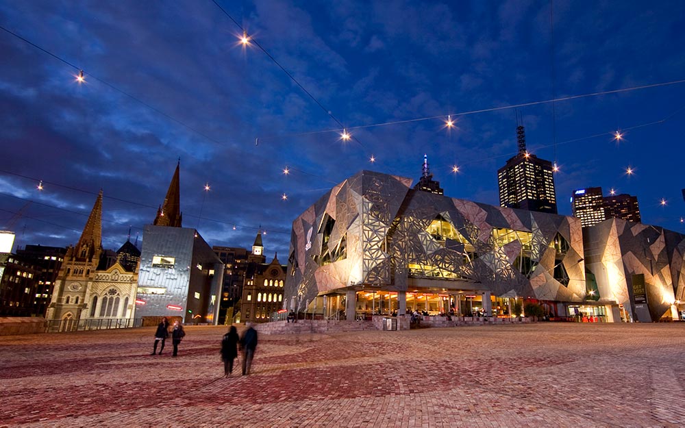 The catenary lighting system pinpoints landscape features and the system creates a unique and inviting ambience to Melbourne's famous Federation Square