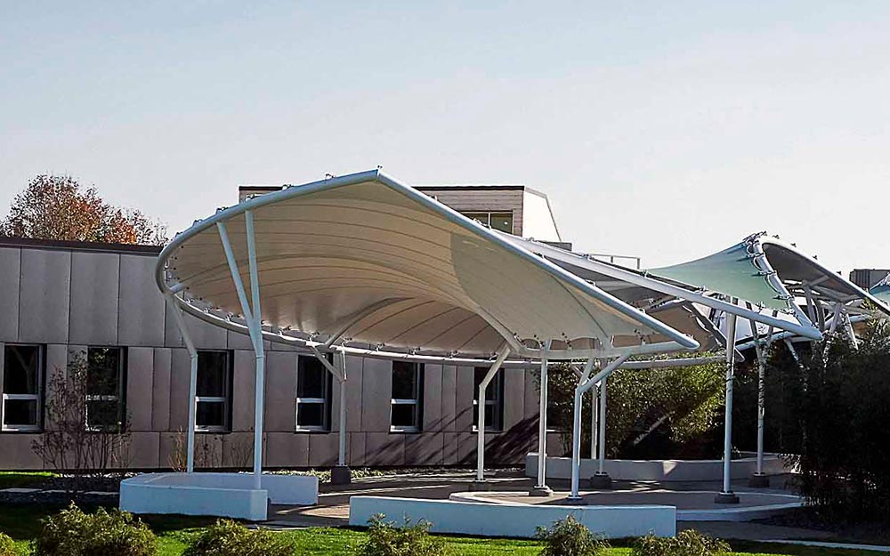 Seaman Corporation is known for their role as a world leader in providing innovative solutions for tomorrow’s high performance industrial fabric needs. Given this, it is fitting that their Wooster, Ohio headquarters main entrance is marked by an installation of striking fabric pavilion structures, which incorporate their own fabric material.