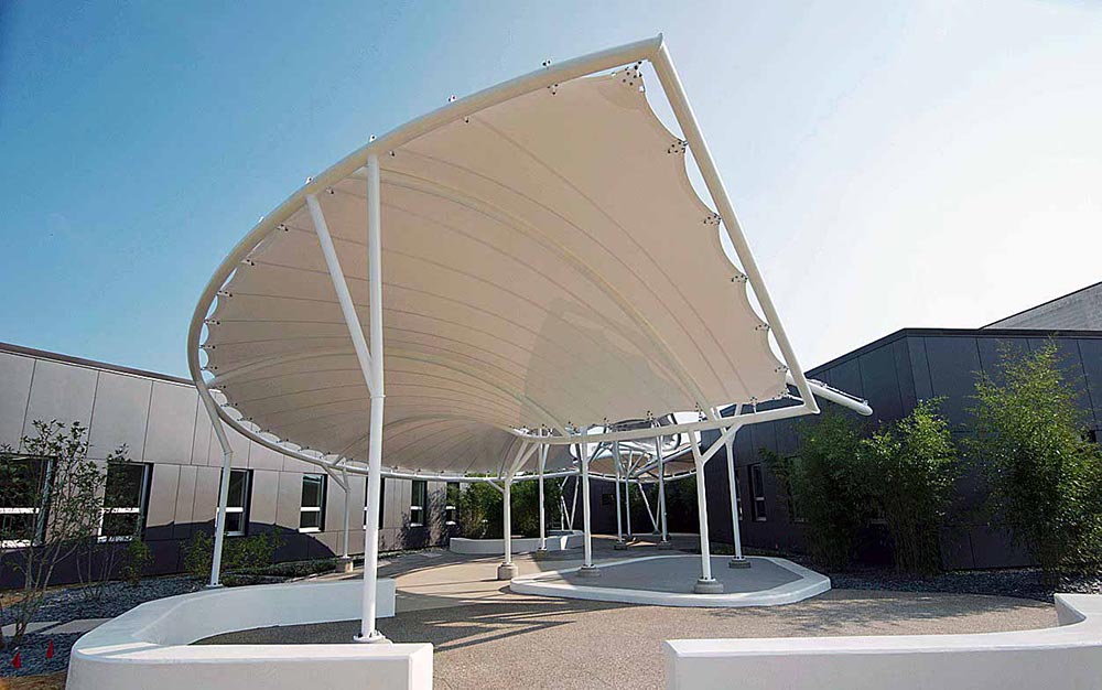 Seaman Corporation is known for their role as a world leader in providing innovative solutions for tomorrow’s high performance industrial fabric needs. Given this, it is fitting that their Wooster, Ohio headquarters main entrance is marked by an installation of striking fabric pavilion structures, which incorporate their own fabric material.